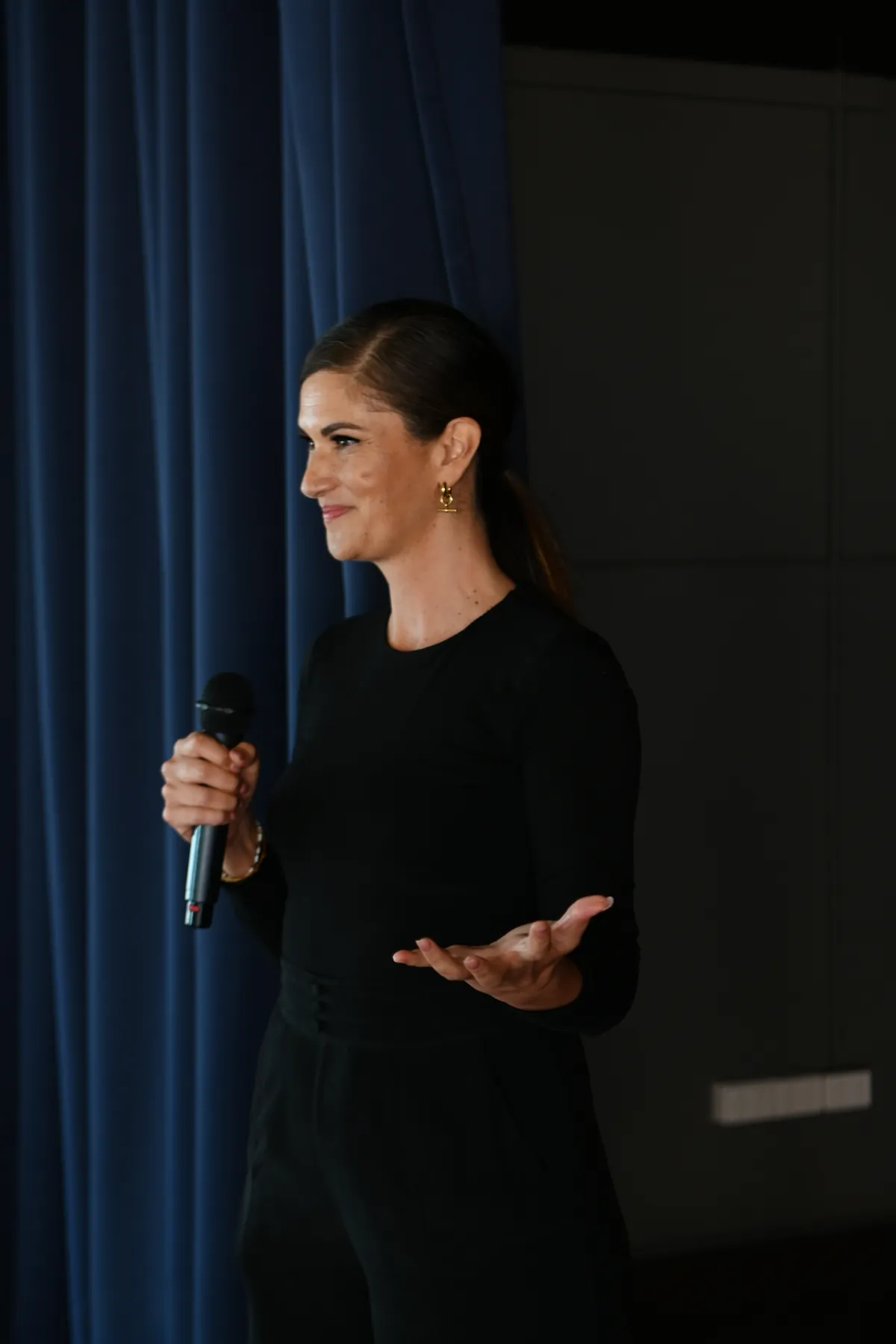 Dr Mel speaking with a microphone